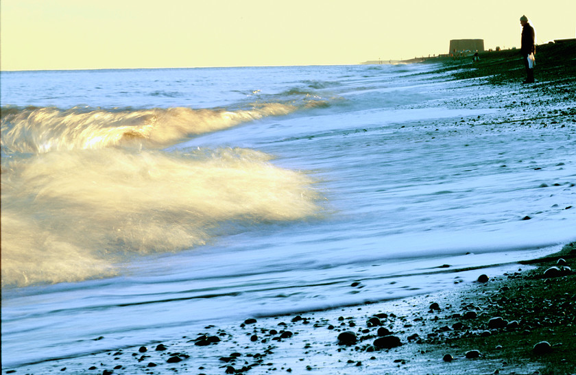 breaking wave on beach with person-1 
 Person by sea watching rolling waves at dusk 
 Keywords: Beach, North, Sea, Suffolk, Sunrise, Sunset, Tony Pick, atmospheric, dawn, dusk, light, movement, nautical, person, tide, waves, yellow